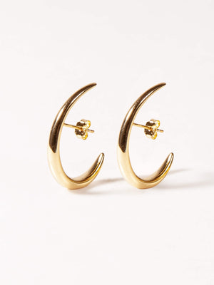 Gold crescent moon earrings on a white background