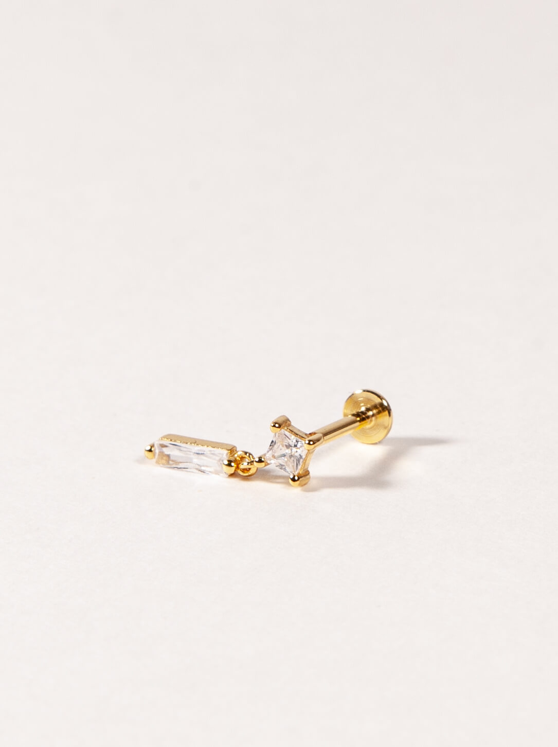 A single sterling silver flatback stud with a dangle design and cubic zirconia embellishment.