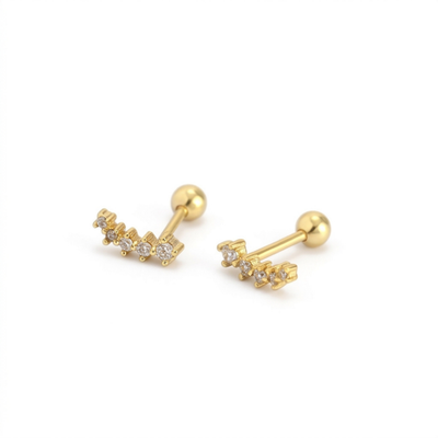 A pair of gold barbell stud earrings with small clear gemstone clusters on each end, displayed on a clean white background.