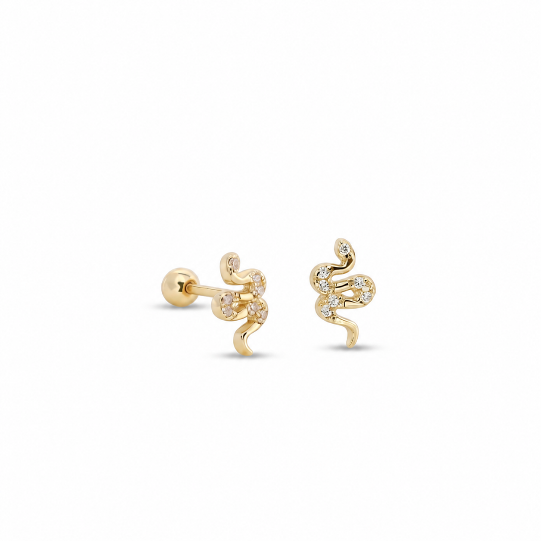 A pair of gold snake stud earrings with small clear gemstones, shown on a clean white background.
