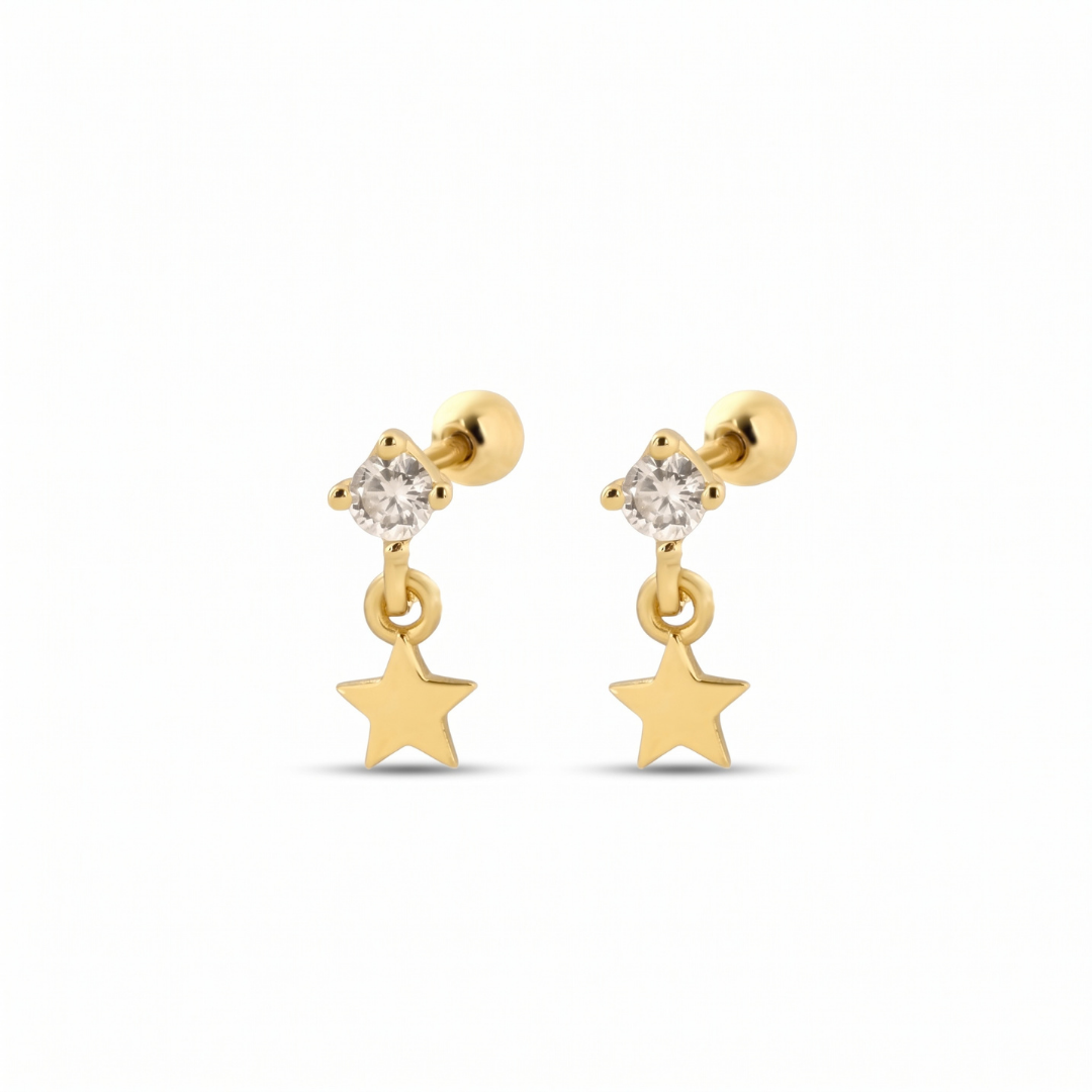 A pair of gold dangle stud earrings featuring a small clear crystal cluster at the top and a dangling five-pointed star charm below, set against a plain white background.
