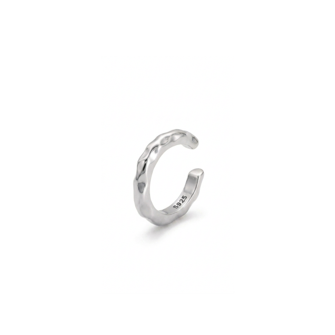 A silver ear cuff with a textured, hammered finish, shown on a clean white background. The inside of the band is stamped with '925' indicating sterling silver.