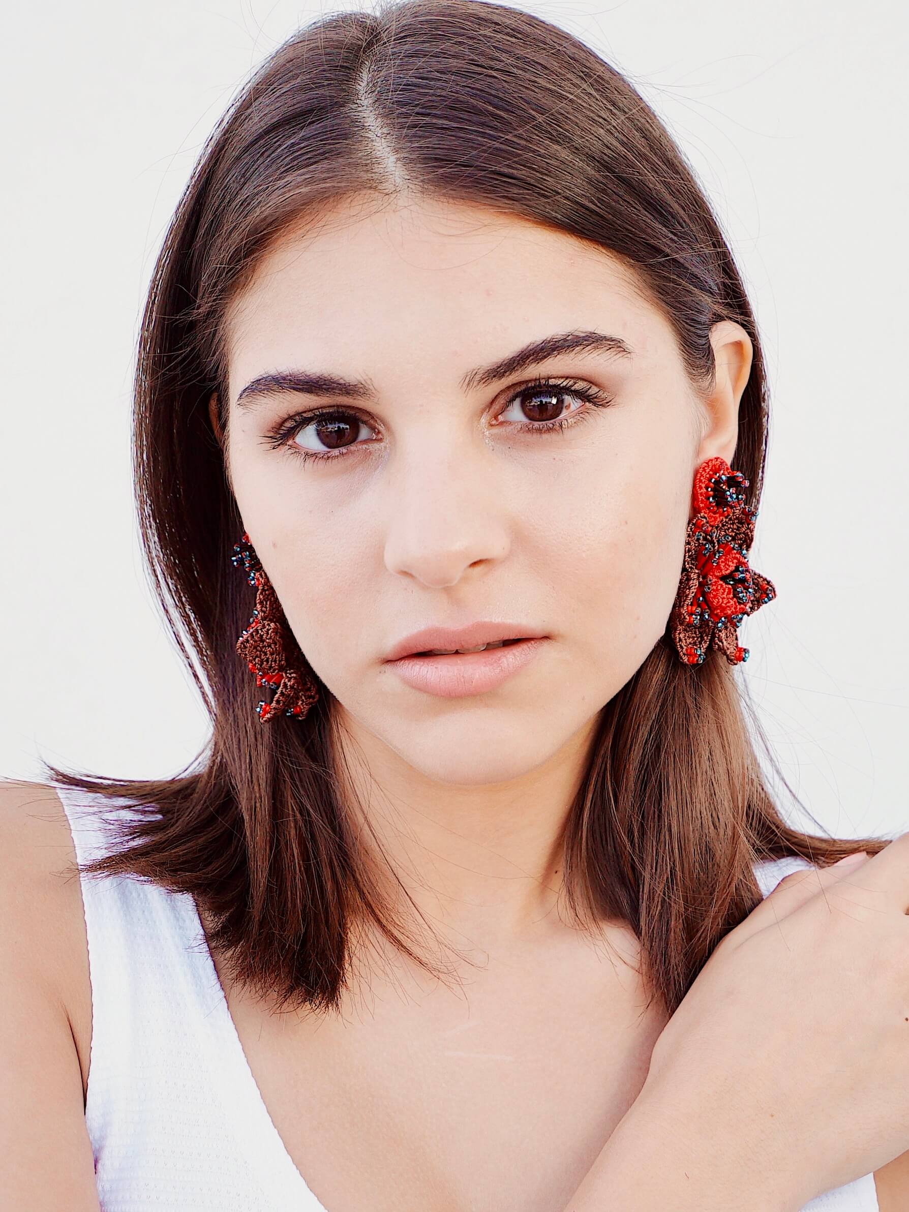 A woman wearing Audrey Bead Embroidery Statement Earrings by Seyyah
